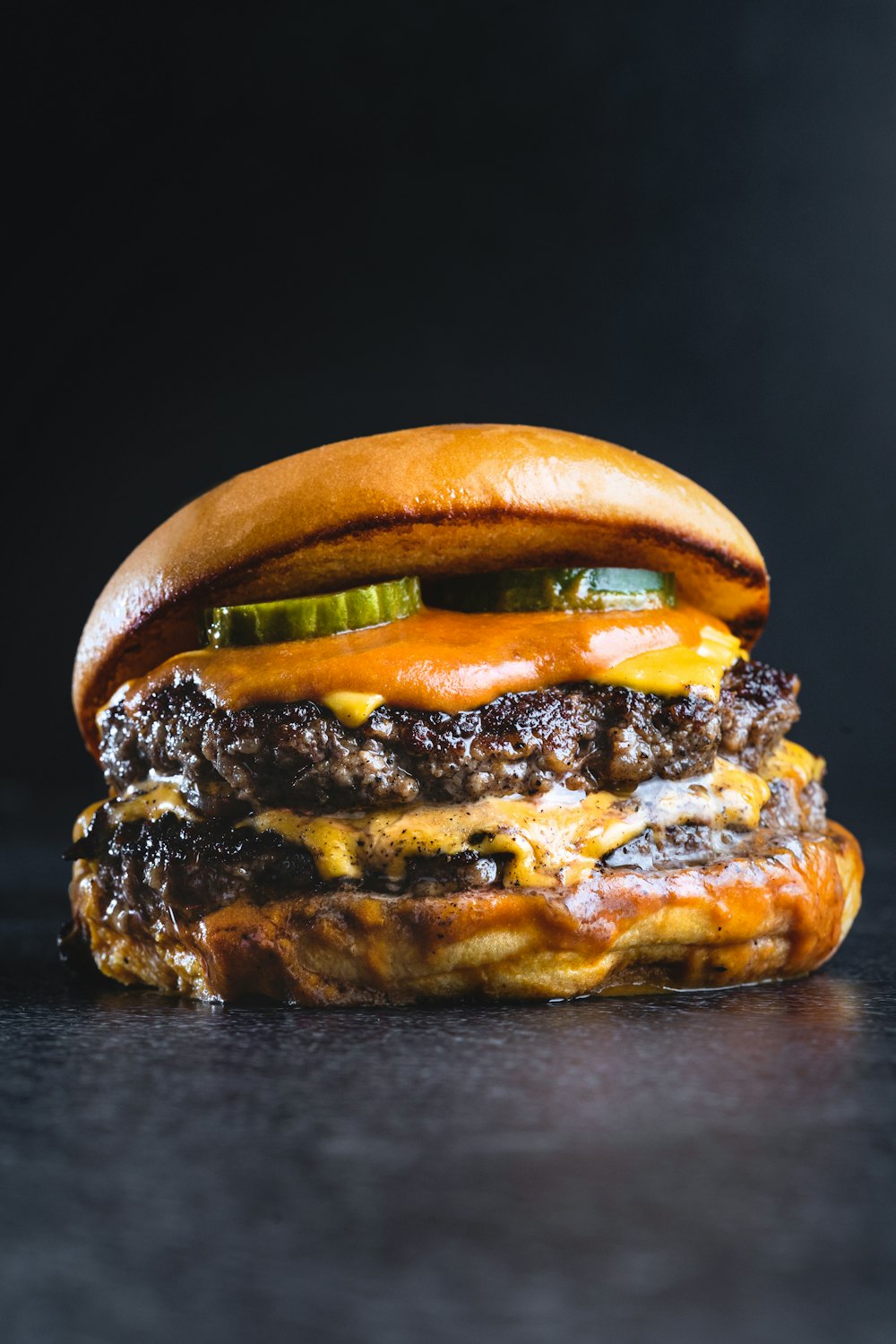Burger dengan keju leleh dan saus oranye